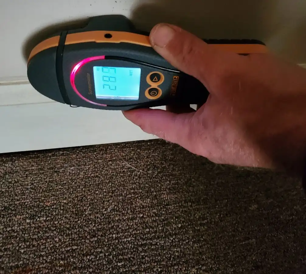 Moisture detection at baseboard during Storm Damage Restoration in Daytona Beach Shores